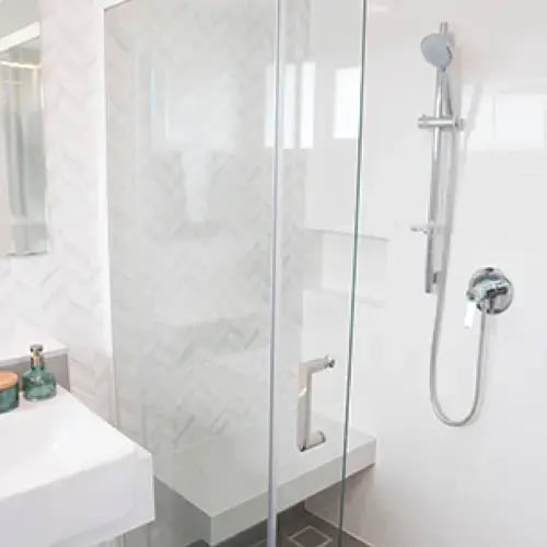 Frameless glass shower door installed in a modern bathroom